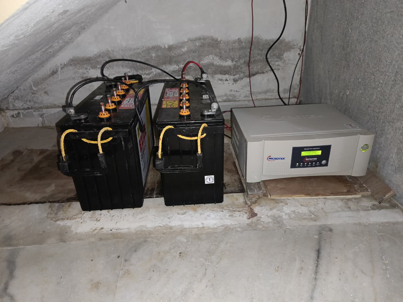Microtek Solar PCU with 2 tall tubular batteries installed for a home solar power system in Hyderabad by Satyajan Energy Solutions.